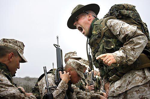 Sgt. David Washington yells at recruits during a water break on a march at Camp Pendleton. The drill instructors will prod and push their charges throughout the grueling 13-week process of becoming a Marine. Youll forget your third-grade teacher, but youll never forget your DI, says Washington, who became a drill instructor to emulate his own DI.