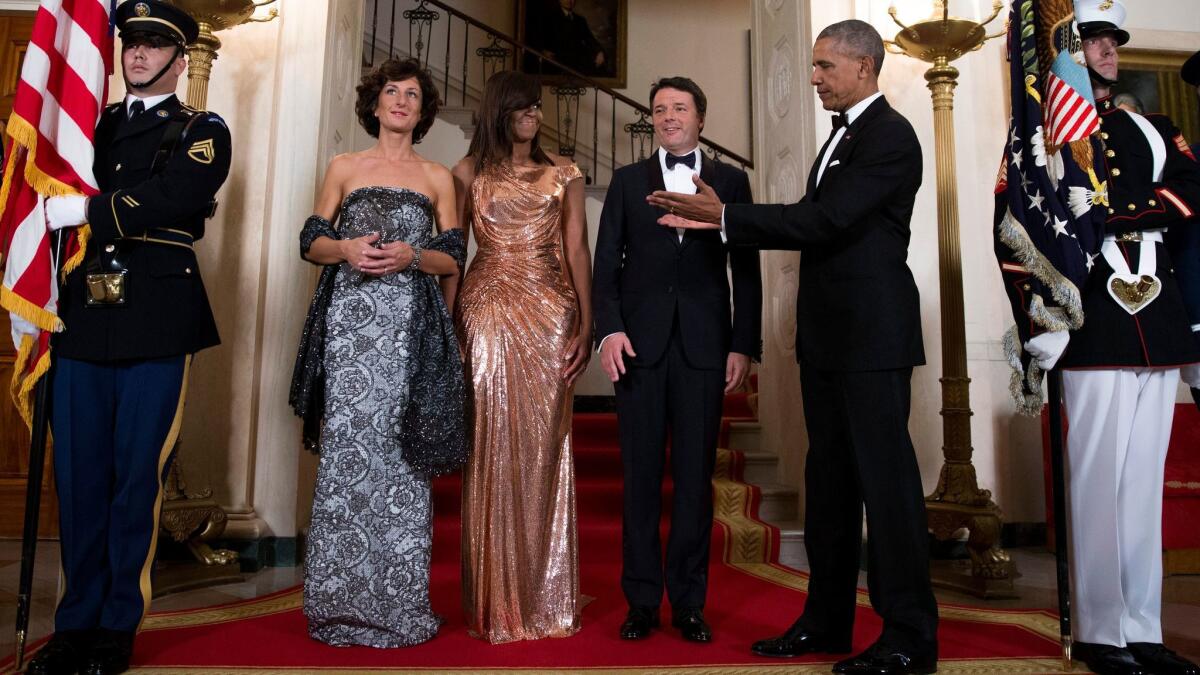 Italy's first lady Agnese Landini, from left, Michelle Obama, Italian Prime Minister Matteo Renzi and President Obama at an October state dinner. The Atelier Versace rose gold chainmail dress gets our vote as one of Mrs. O's most memorable looks.