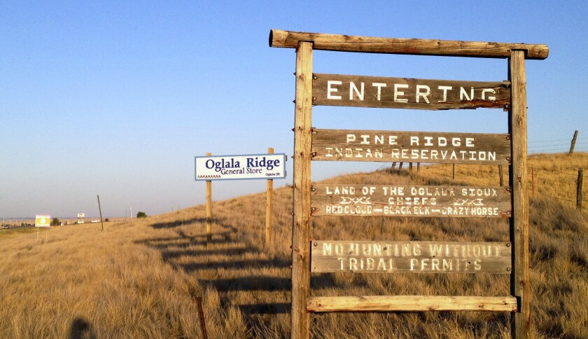 A sign reads, "Entering Pine Ridge Indian Reservation."