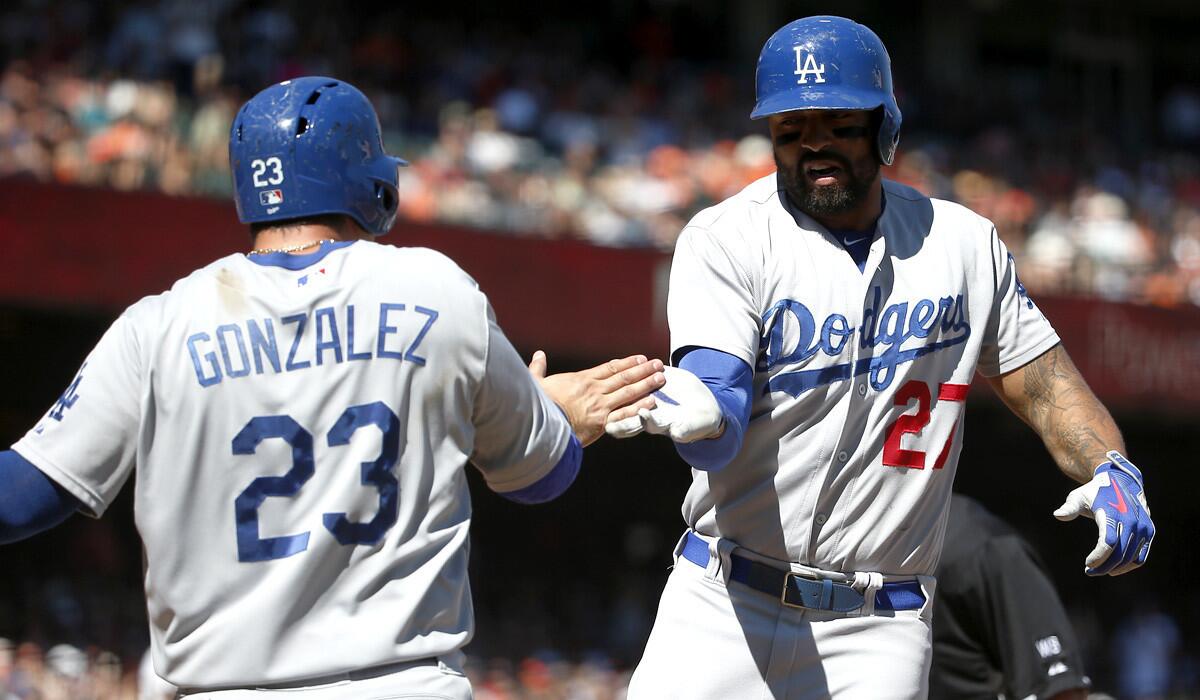 Dodgers right fielder Matt Kemp and first baseman Adrian Gonzalez celebrate after Kemp's two-run home run against the Giants in the sixth inning Sunday.