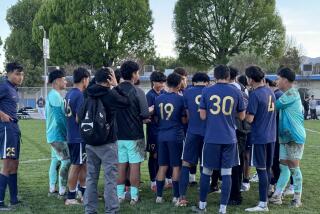 Birmingham players meet after 5-0 City Section Division I semifinal soccer win over Fremont.