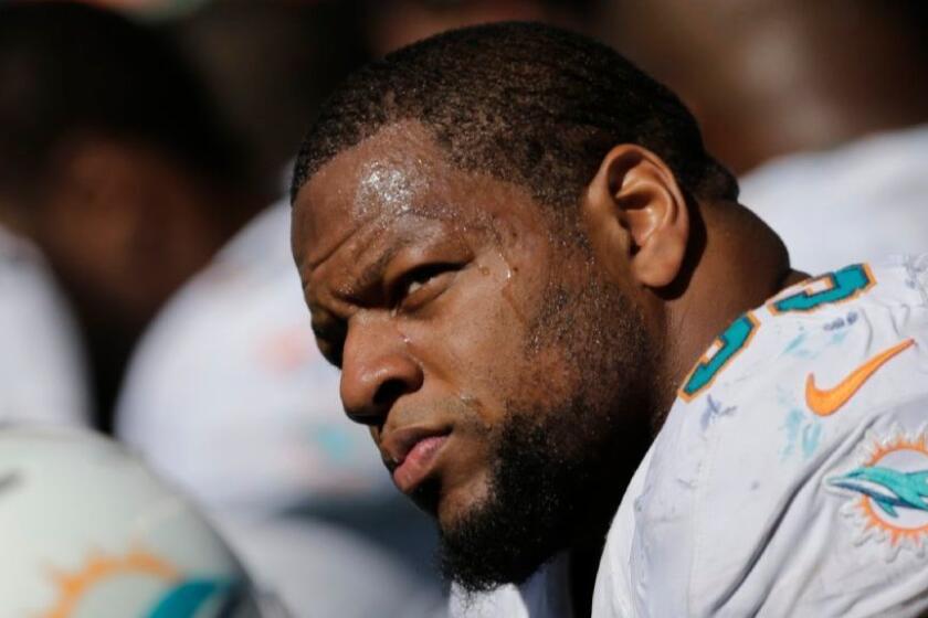 Dolphins defensive tackle Ndamukong Suh sits on the sideline during the first half of a game against the Seahawks on Sept. 11.