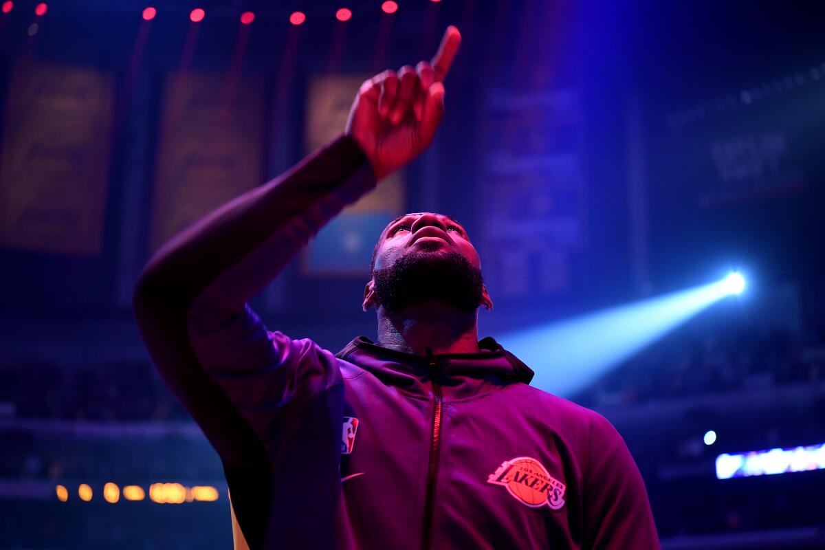 LeBron James points upward after the completion of the national anthem before a game Jan. 13, 2020, at Staples Center.