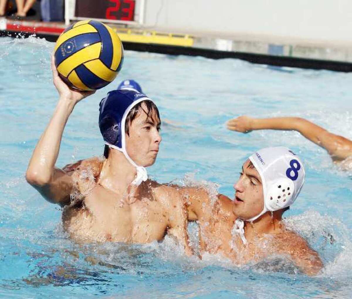 Flintridge Prep's Alex Blaine winds up for a shot against the defense of San Marino's Nick Lakon in the Rebels' 16-2 win over the Titans.