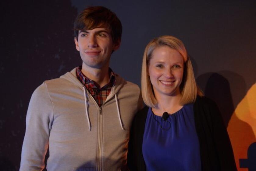 Yahoo CEO Marissa Mayer and Tumblr founder David Karp pose for a photo after announcing Yahoo's purchase of Tumblr.