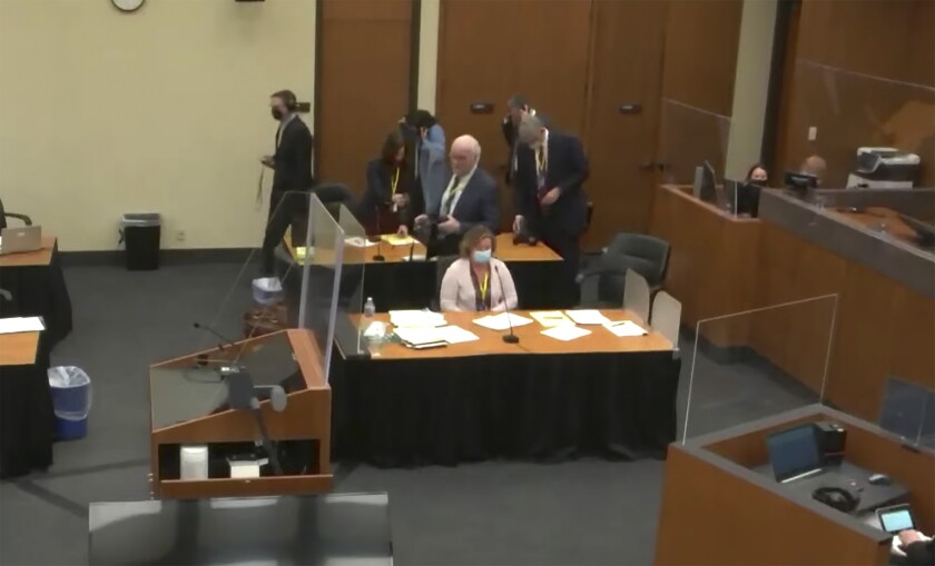 In this screen grab from video, former Brooklyn Center police Officer Kim Potter sits at the defense table, center, as Hennepin County Judge Regina Chu presides over jury selection Tuesday, Nov. 30, 2021, in the trial of Potter in the April 11, 2021, death of Daunte Wright, at the Hennepin County Courthouse in Minneapolis, Minn. (Court TV via AP, Pool)