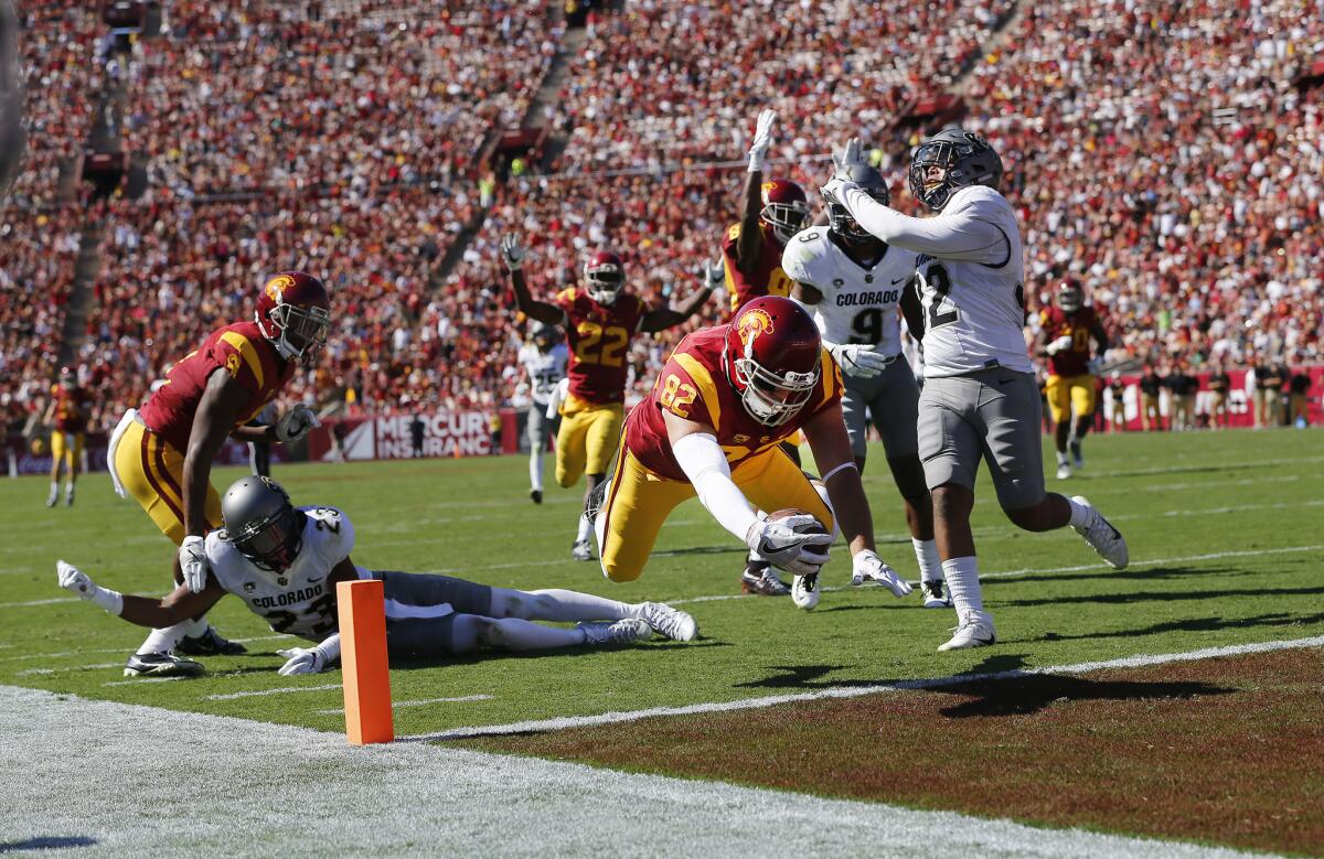 Trojans tight end Tyler Petite (82) leaps into the end zone to score after a pass from quarterback Sam Darnold in the second quarter.