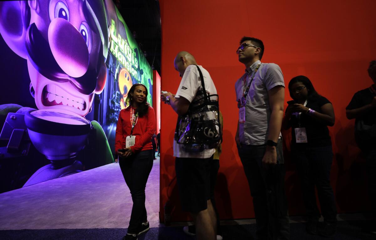 Attendees wait in line for Nintendo’s “Luigi’s Mansion 3” during E3 at the Los Angeles Convention Center.
