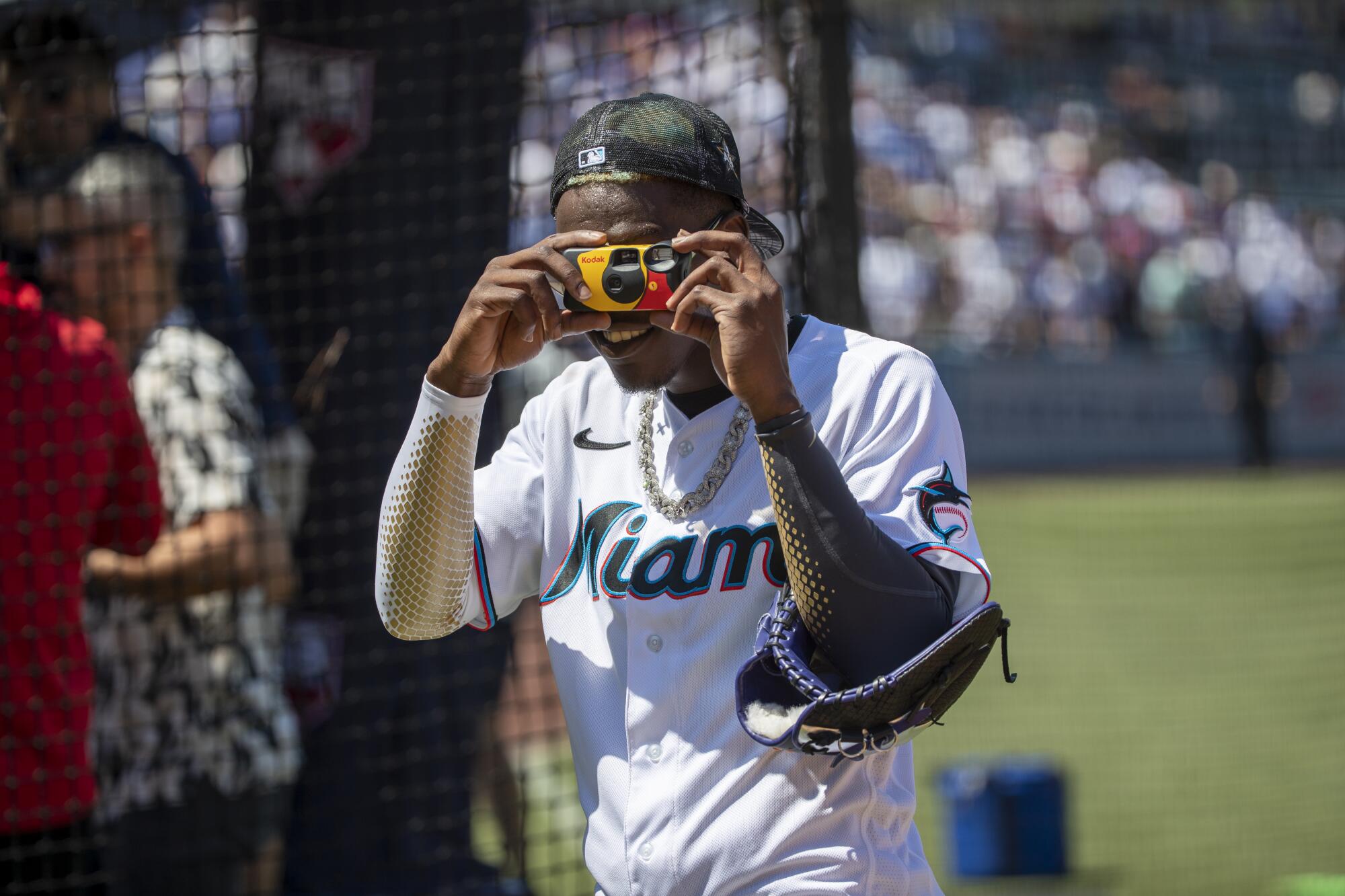 Miami Marlins' Jazz Chisholm takes a snapshot of the media during All-Star workouts