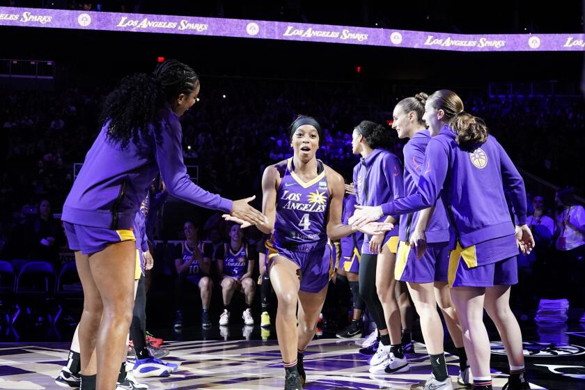 The Sparks' Lexie Brown is cheered by teammates as she is introduced before a preseason game 