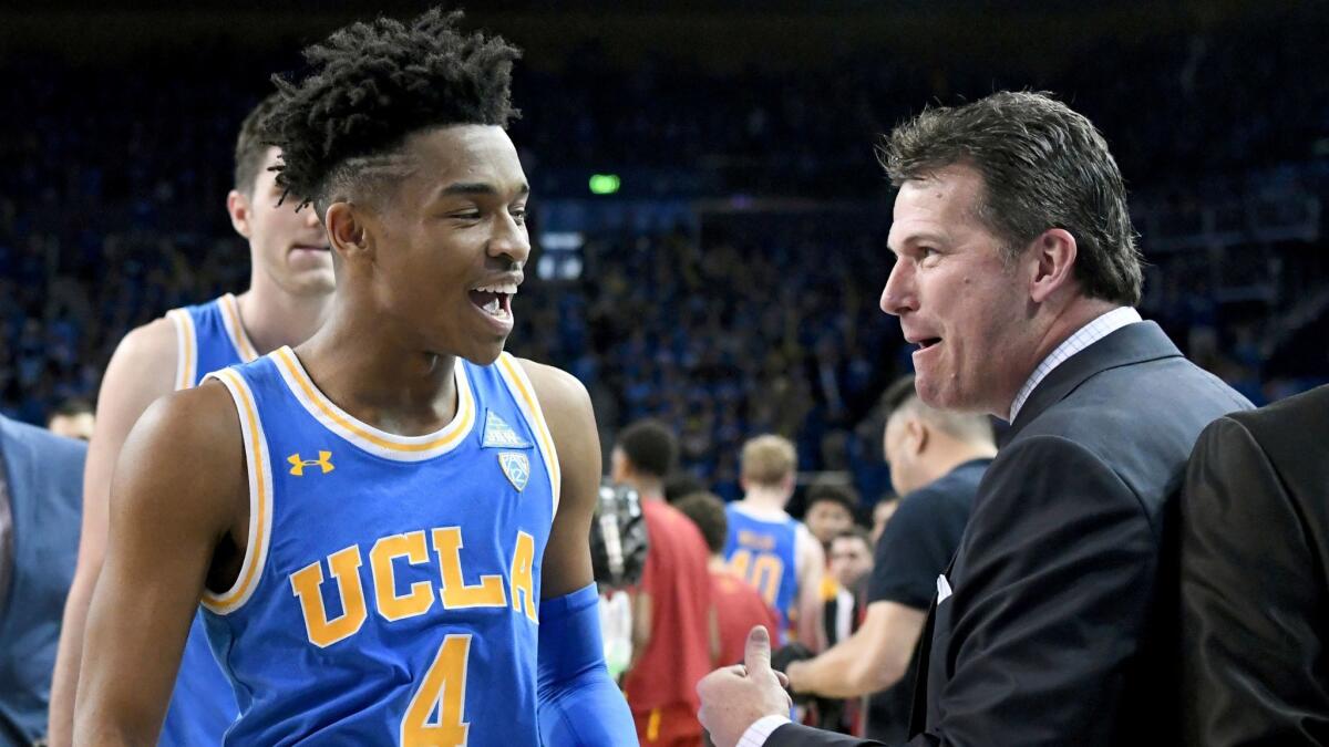 UCLA guard Jaylen Hands, left, celebrates with coach Steve Alford following a win over USC on Feb. 3.