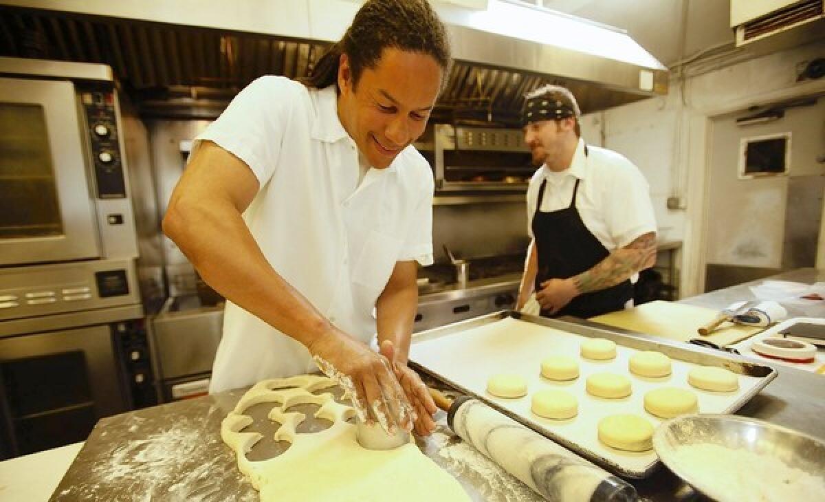 Chef Govind Armstrong, left, with chef Greg Zanotti, prepares biscuits in the kitchen of his Willie Jane restaurant in Venice.