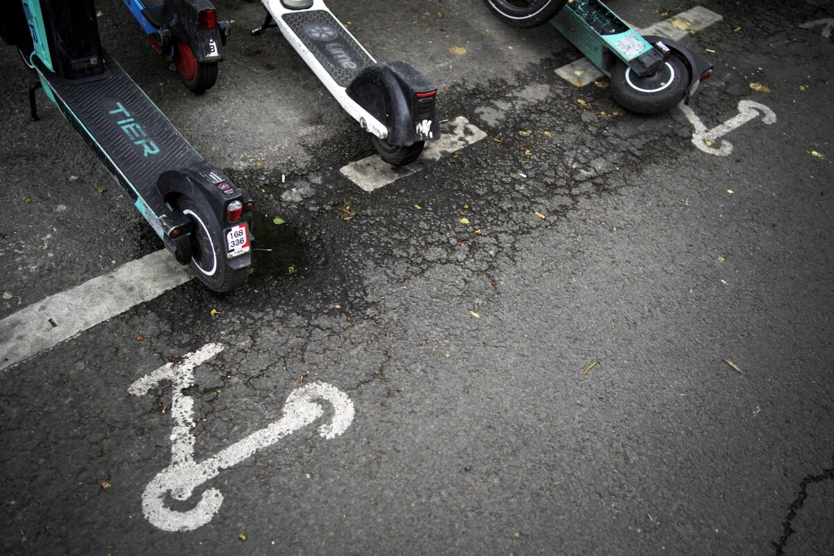 Electric scooters parked on a Paris street