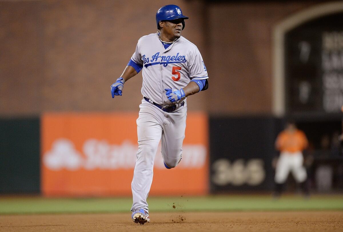 Dodgers third baseman Juan Uribe round the bases after hitting a two-run home run against the San Francisco Giants on Friday.