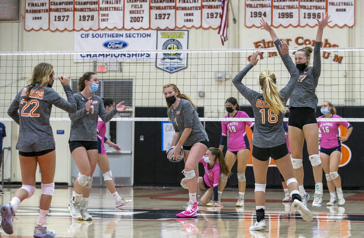 Huntington Beach celebrates winning a point in the third set against Tesoro.