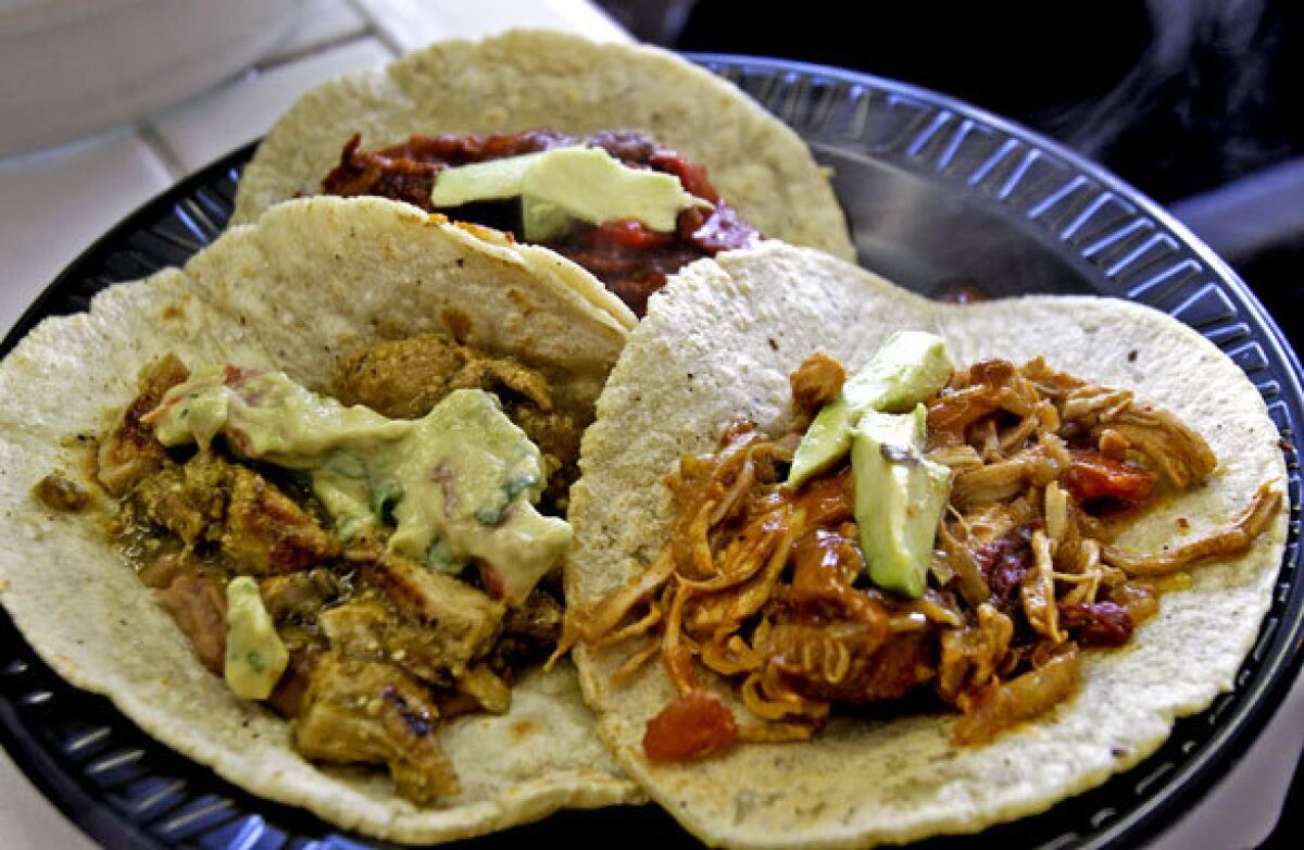Pork in salsa verde, left, beef steak in pimento, rear, and tinga chicken are served on freshly made tortillas.