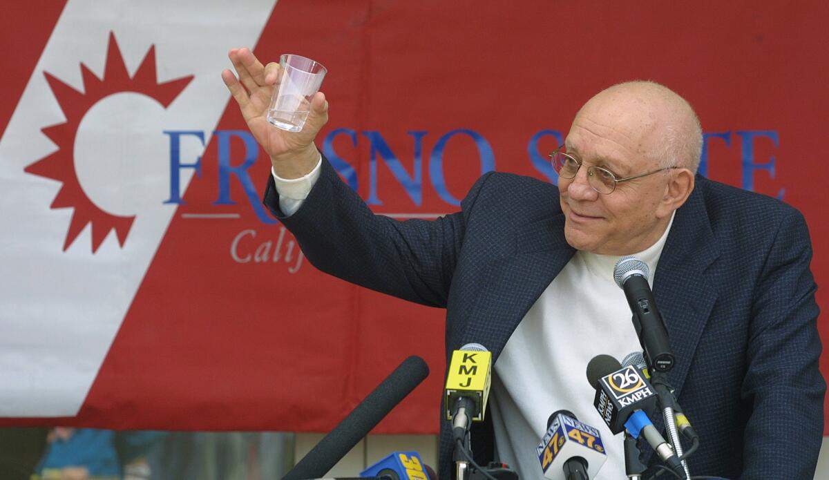Jerry Tarkanian raises a glass in announcing his retirement as Fresno State coach on March 15, 2002. Tarkanian finished with a 778-202 career coaching record.