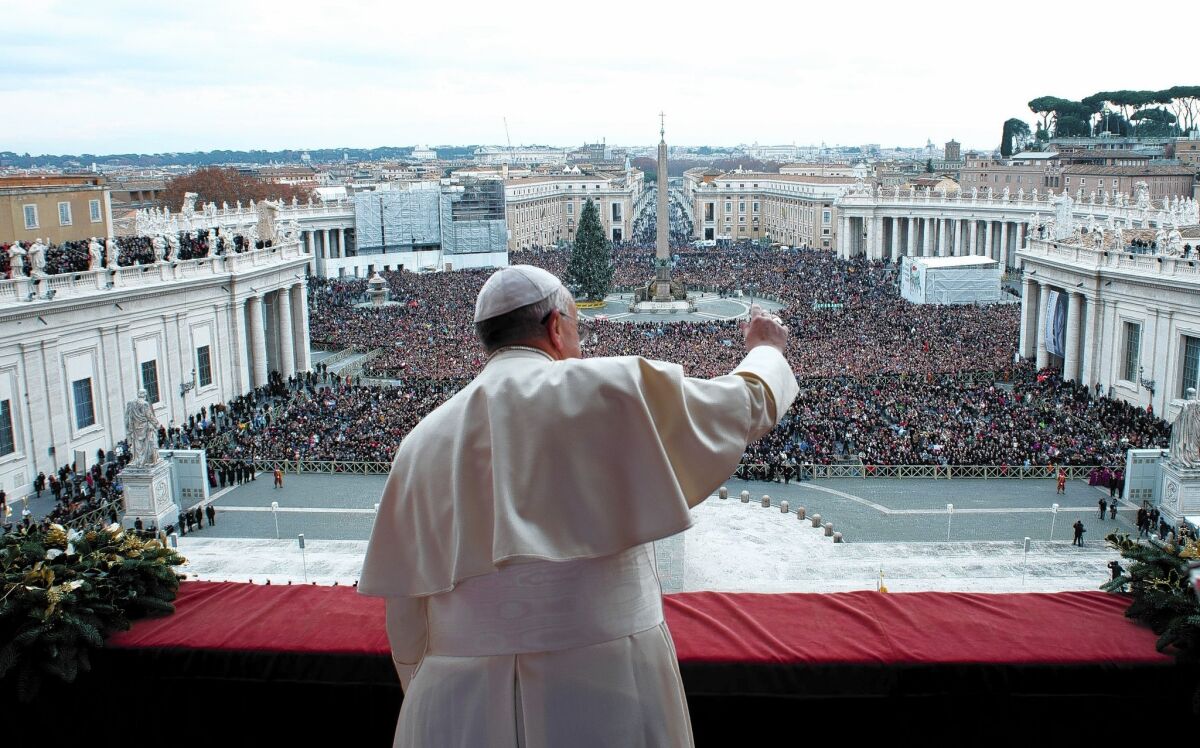 Pope Francis gives a Christmas blessing from the balcony of St. Peter's Basilica at the Vatican.