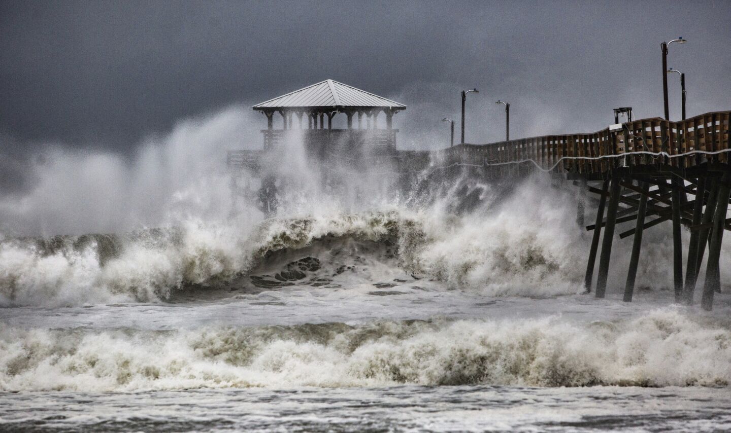 Waves slam the Oceanana Pier & Pier House Restaurant in Atlantic Beach, N.C.