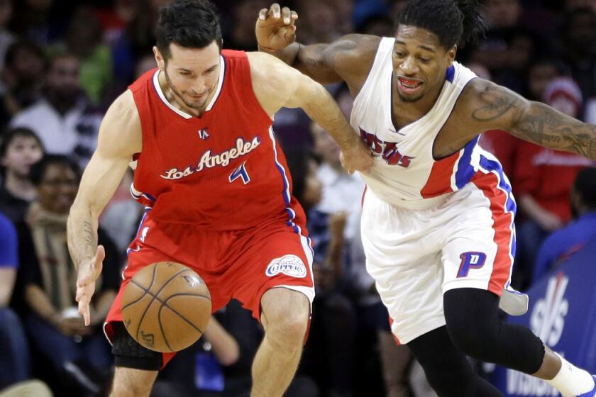 Clippers guard J.J. Redick (4) and Pistons forward Cartier Martin chase after a loose ball during the first half of their game Wednesday in Auburn Hills, Mich.