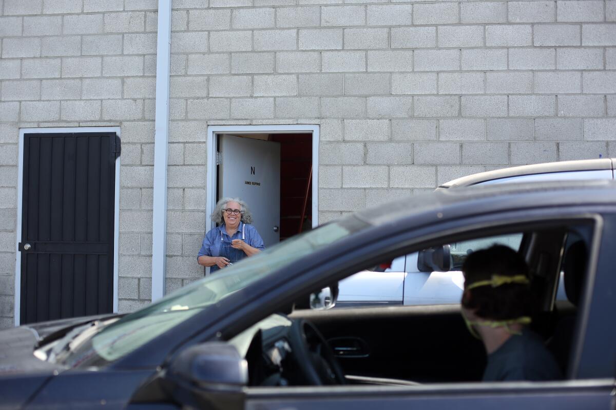 Ian Byers-Gamber pulls up in front of Alison Saar's studio in North Hollywood in a black Honda. 