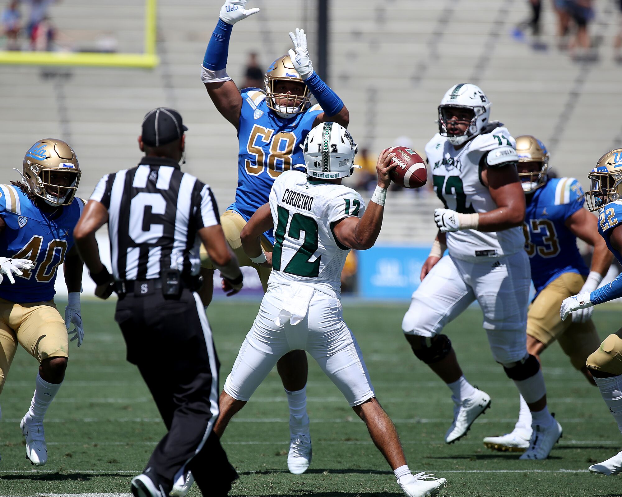 UCLA defensive lineman Datona Jackson tries to deflect a pass by Hawaii quarterback Chevan Cordeiro in the second quarter.