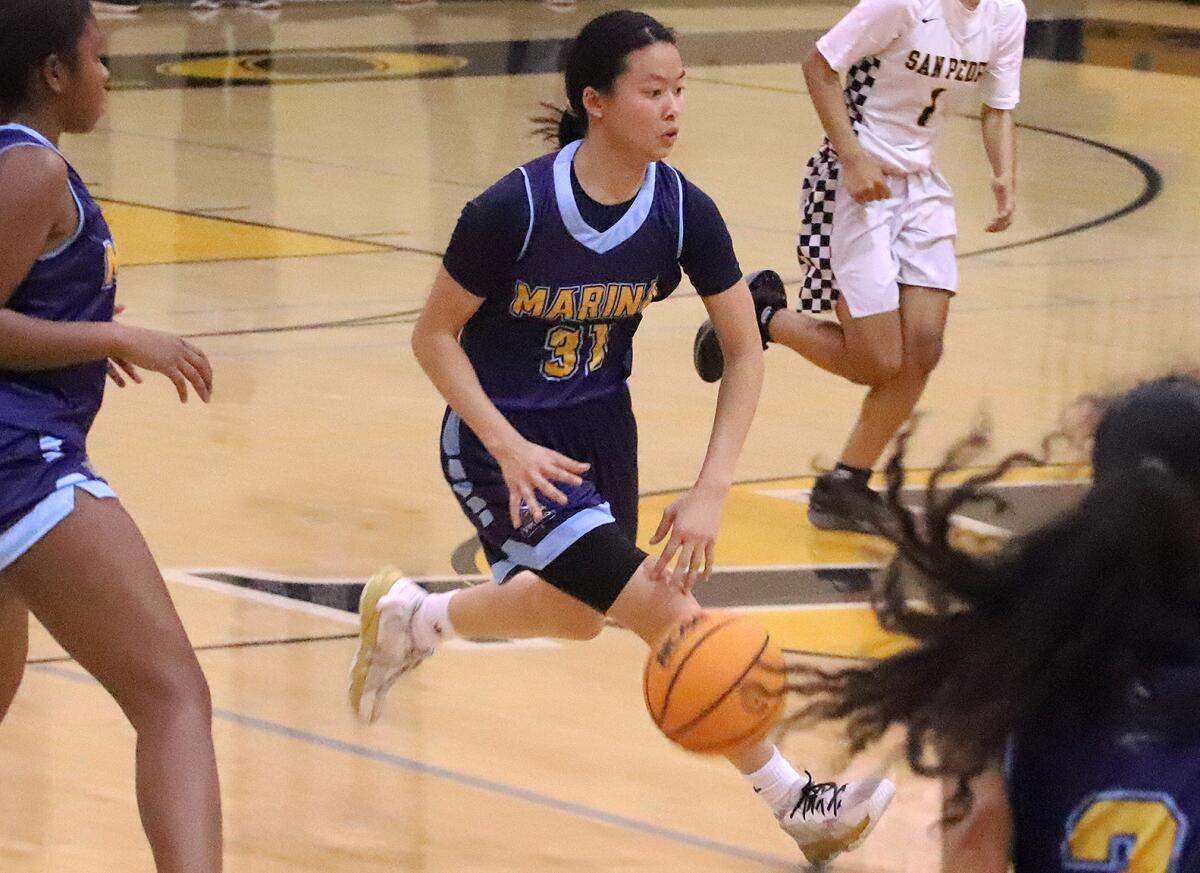 Marina's Tiana To (31) dribbles up court against San Pedro on Tuesday.