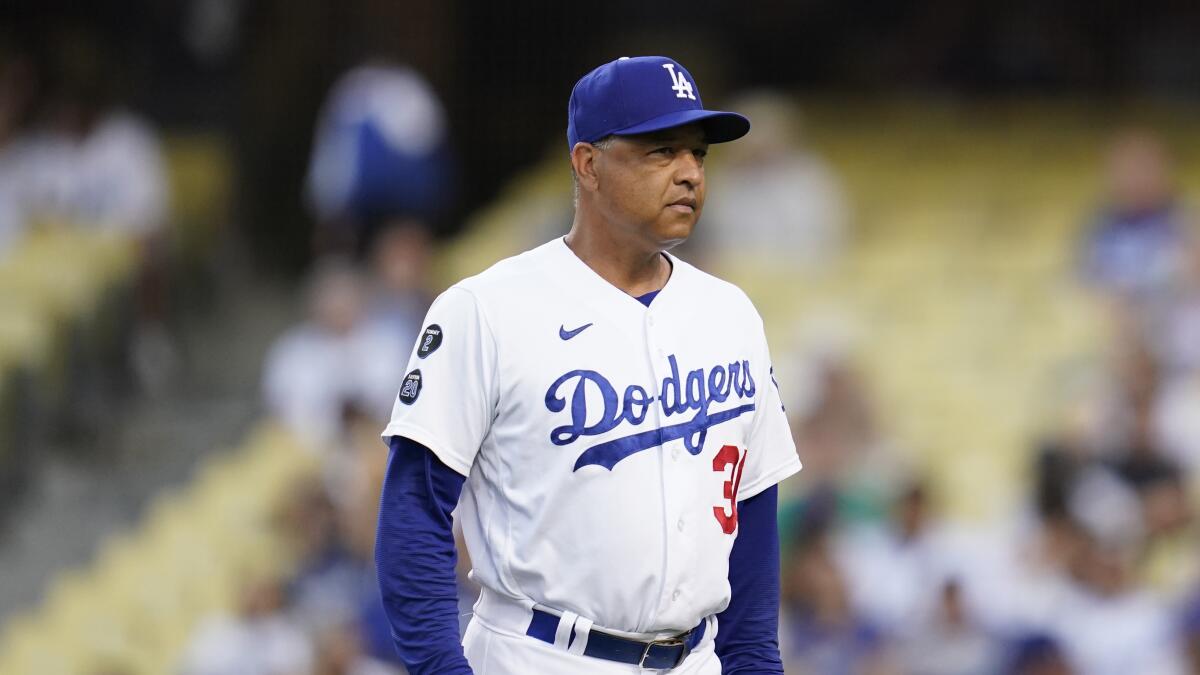 Los Angeles Dodgers manager Dave Roberts (30) walks to the dugout before a game 
