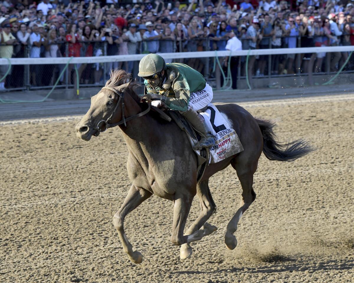 Code of Honor, with jockey John Velazquez, wins the Travers Stakes.
