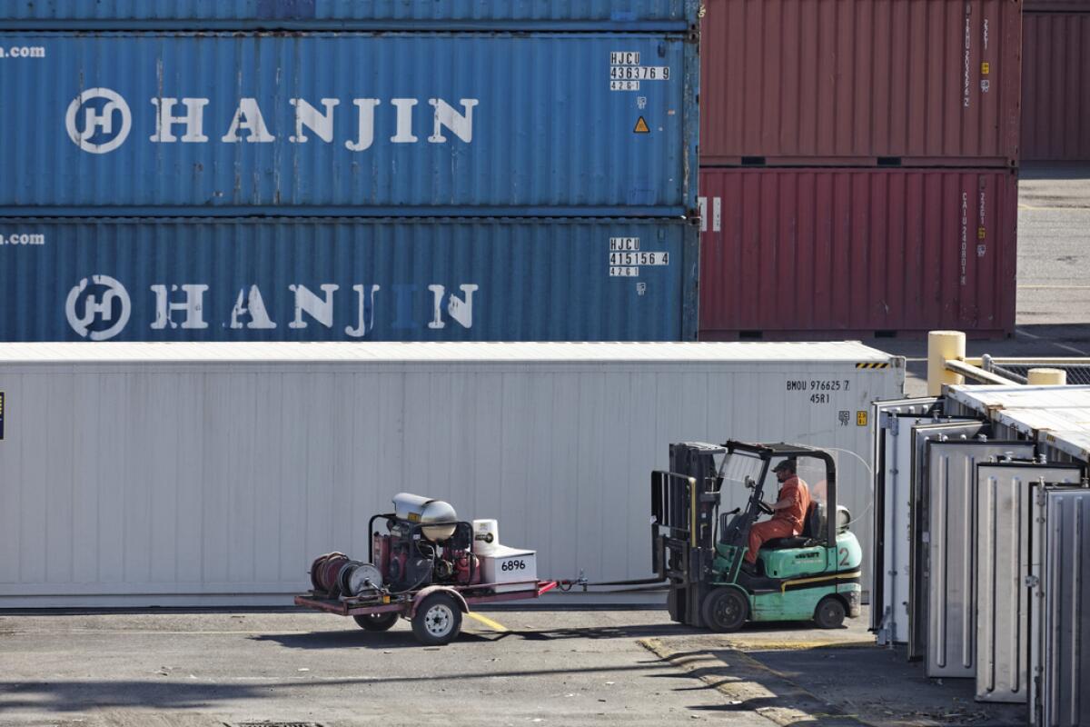 A union electrician moves equipment in 2012 at the international container cargo terminal in Portland, Ore. The West Coast longshore union's attempt to wrest control of two jobs conducted by electricians at the Port of Portland backfired, resulting in a jury award that could cause the dockworkers' organization to file for bankruptcy protection.
