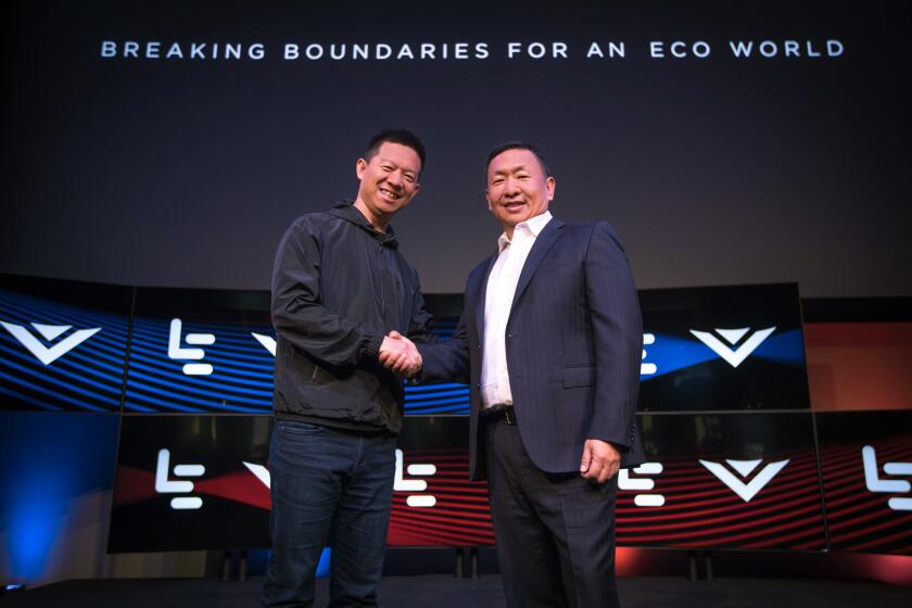 LeEco Chief Executive Jia Yueting, left, and Vizio CEO William Wang shake hands after announcing the acquisition of the Irvine TV maker last week.