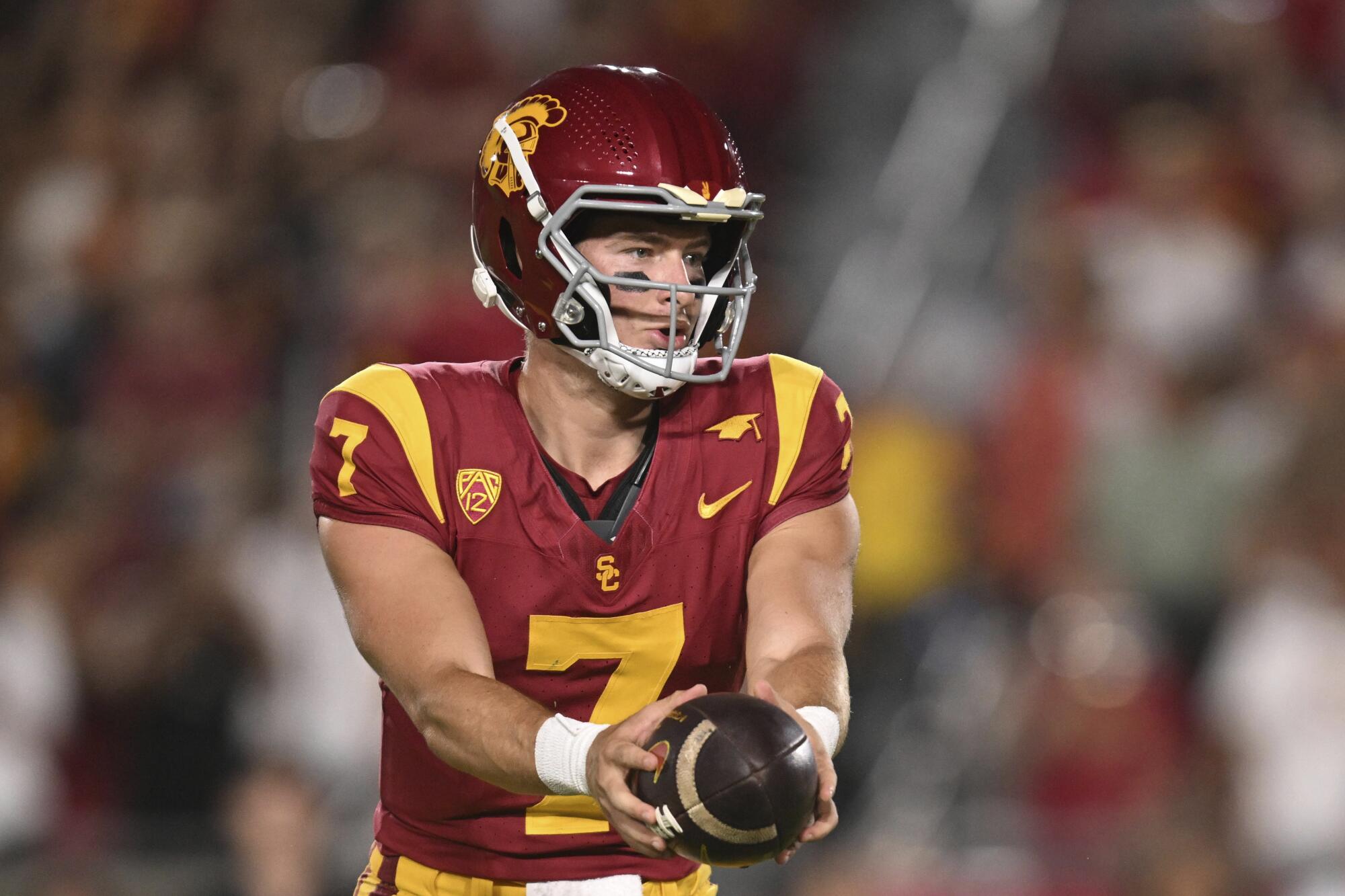USC quarterback Miller Moss hands off the ball during a game against San José State 