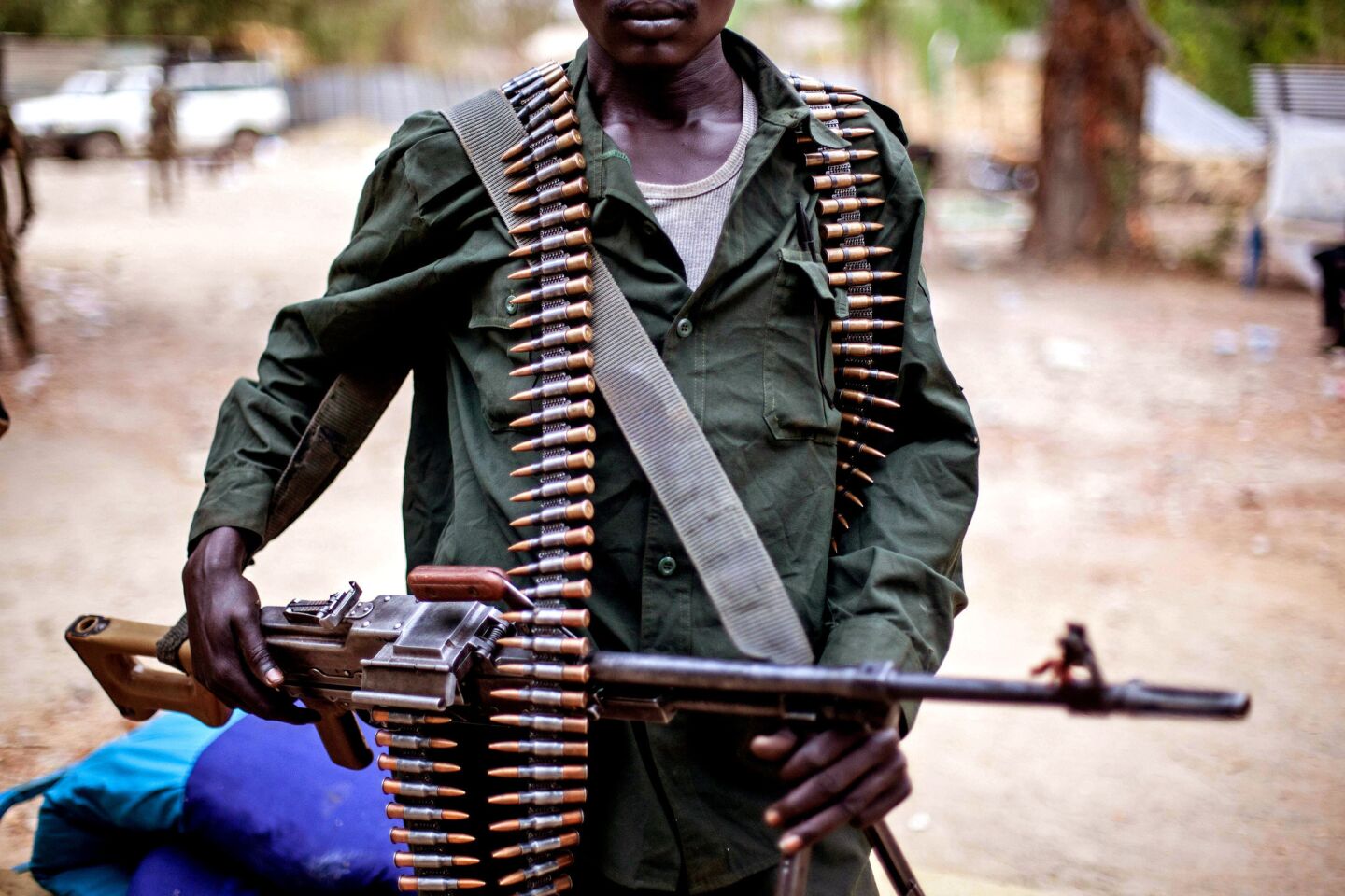 A member of South Sudanese antigovernment forces wields a machine gun in Malakal.
