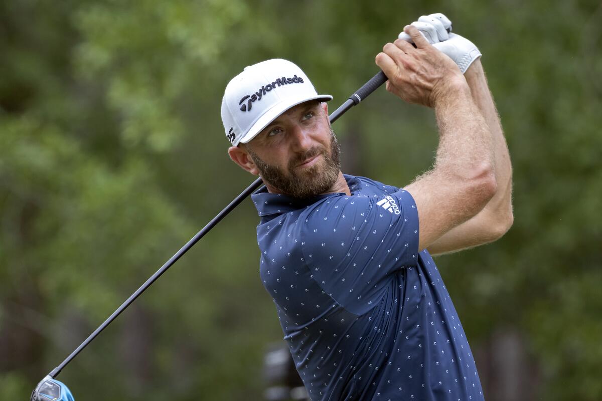 CORRECTS FARAWAY TO FAIRWAY Dustin Johnson watches his drive down the ninth fairway during the first round of the Palmetto Championship golf tournament in Ridgeland, S.C., Thursday, June 10, 2021. (AP Photo/Stephen B. Morton)