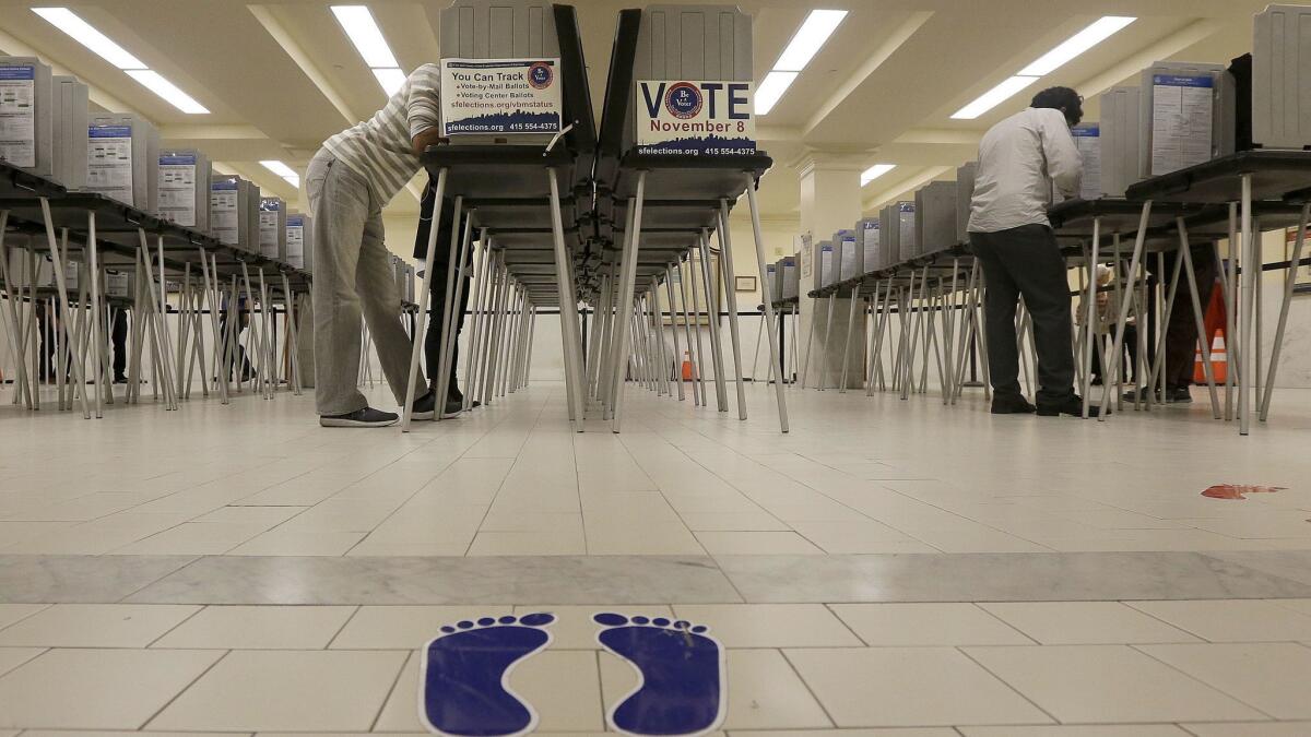 In this Nov. 8, 2016 file photo, voters cast ballots at City Hall in San Francisco.