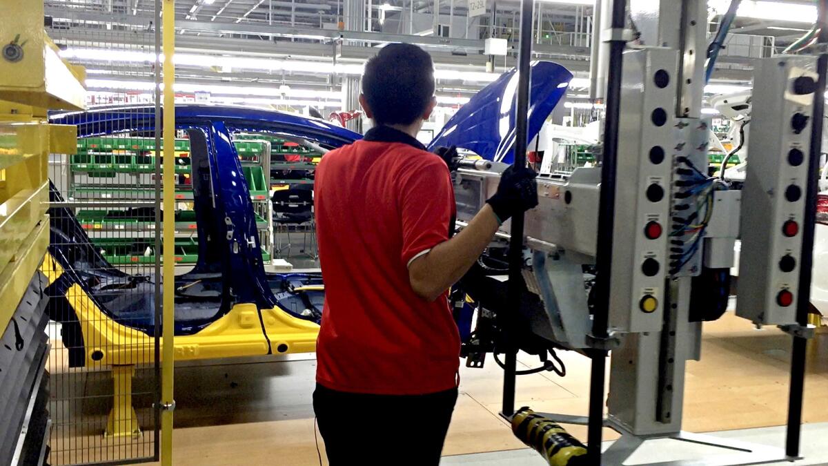 A worker assembles the Forte sedan on the floor of a Kia plant in Nuevo Leon, Mexico.