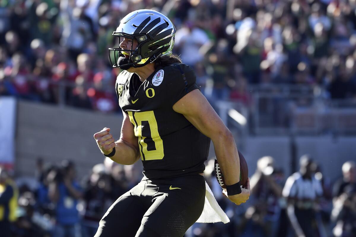 Oregon quarterback Justin Herbert celebrates after scoring a touchdown against Wisconsin during the Rose Bowl.
