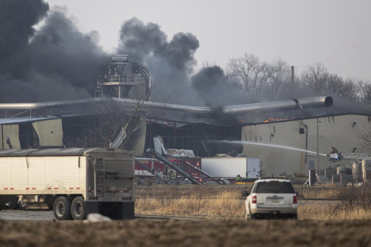 Firefighters work to control a blaze at a grain elevator, Thursday, Dec. 8, 2022, in Marengo, Iowa. An explosion has caused injuries and an evacuation of people near the operation. The explosion and fire happened about 11:15 a.m. Thursday in Marengo at a grain elevator owned by Heartland Crush. (Joseph Cress/Iowa City Press-Citizen via AP)