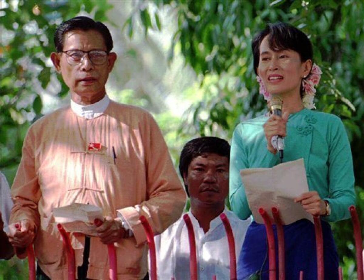 FILE - In this June 9, 1996 file photo, pro-democracy leader Aung San Suu Kyi, right, speaks to crowds gathered outside the gates of her home as the National League for Democracy Party's Vice Chairman Tin Oo stands at left in Yangon, Myanmar. Myanmar's military government has freed Tin Oo, 82-year-old deputy leader of Suu Kyi, Saturday, Feb. 13, 2010 after nearly seven years in detention. Suu Kyi remains under house arrest. (AP Photo/Stuart Isett, File)