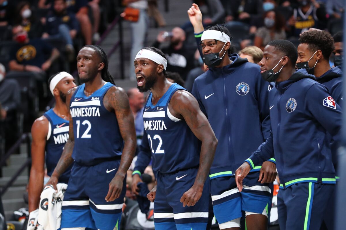 Patrick Beverley shouts from the bench with his Minnesota Timberwolves teammates