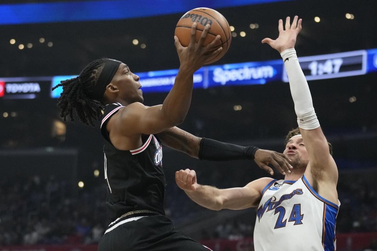 The Clippers' Terance Mann drives against the Wizards' Corey Kispert on Dec. 17, 2022.