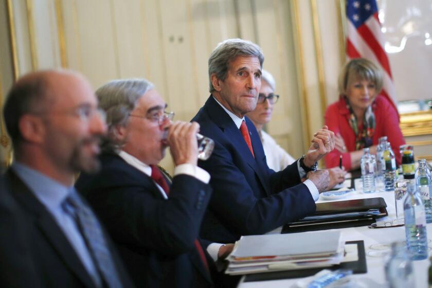 Secretary of State John F. Kerry, center, during nuclear talks with the Iranian foreign minister in Vienna on Friday.