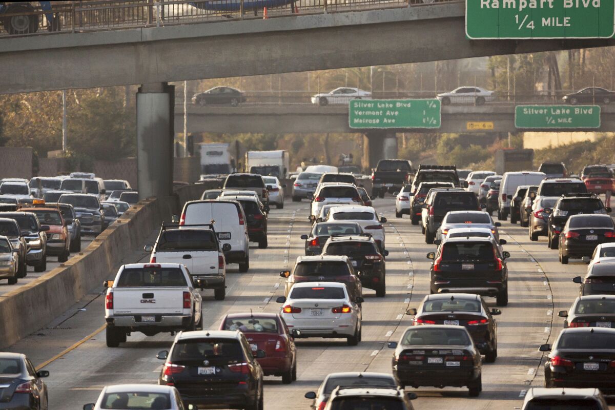 FILE - Traffic travels along the Hollywood Freeway in Los Angeles on Dec. 12, 2018. According to a report published in the Proceedings of the National Academy of Sciences on Monday, Dec. 13, 2021, researchers who study the environment and public health say that thousands of lives and hundreds of billions of dollars have been saved in the United States by recent reductions in emissions from vehicles. (AP Photo/Damian Dovarganes, File)