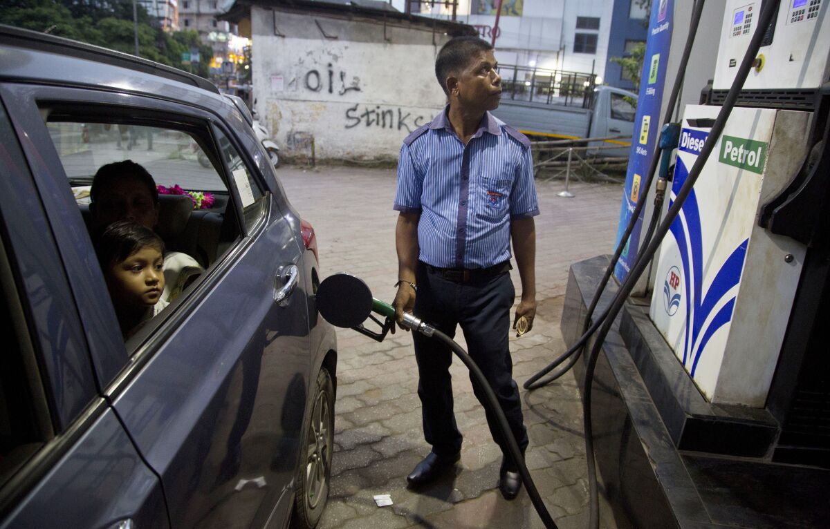 FILE - A man fills his car at a gasoline station in Gauhati, India, Sunday, Sept. 22, 2019. The state-run Indian Oil Corp. bought 3 million barrels of crude oil from Russia earlier this week to secure its energy needs, resisting Western pressure to avoid such purchases, an Indian government official said Friday, March 18, 2022. (AP Photo/Anupam Nath, File)