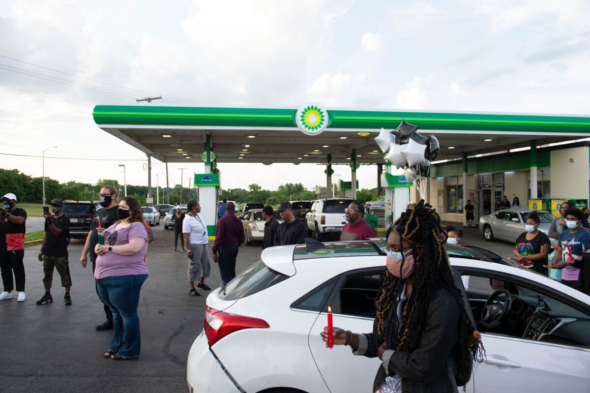 Members of the community gather for a vigil on the corner of 67th and Prospect in Kansas City, Missouri, Wednesday, June 2, 2021, at the BP gas station where Malcolm Johnson was shot and killed by police on March 25. (Rebecca Slezak/The Kansas City Star via AP)
