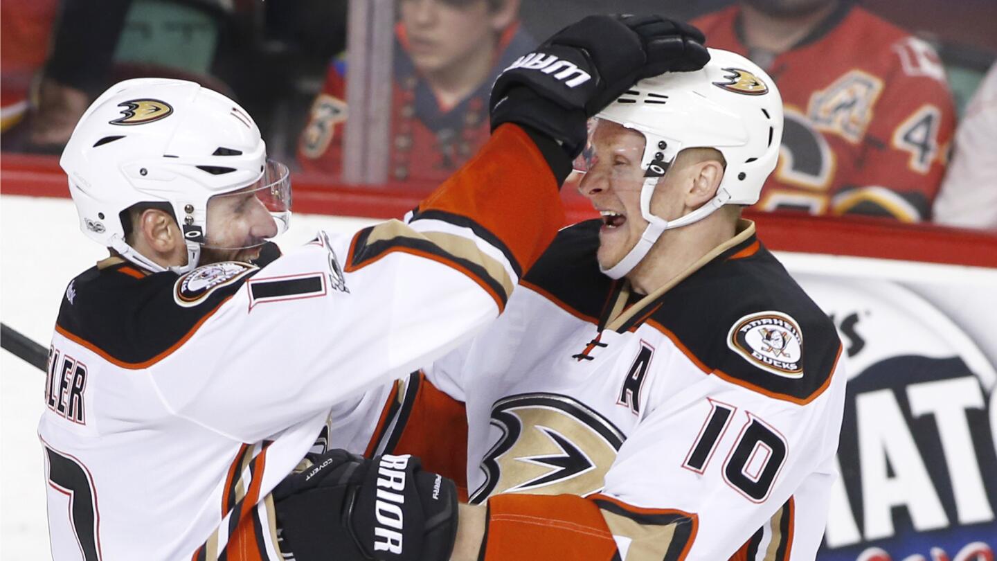 Ducks forward Corey Perry, right, celebrates his goal against the Calgary Flames with Ryan Kesler during overtime.