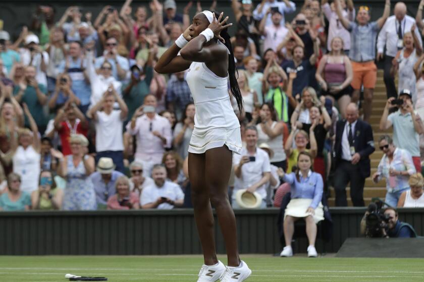 United States' Cori "Coco" Gauff celebrates after beating Slovenia's Polona Hercog in a Women's singles match during day five of the Wimbledon Tennis Championships in London, Friday, July 5, 2019. (AP Photo/Ben Curtis)