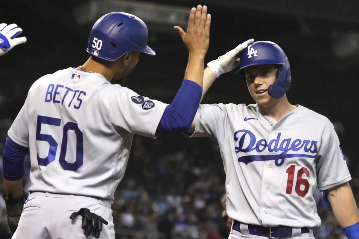 Will Smith, right, celebrates with Dodgers teammate Mookie Betts after hitting a two-run home run in the first inning.