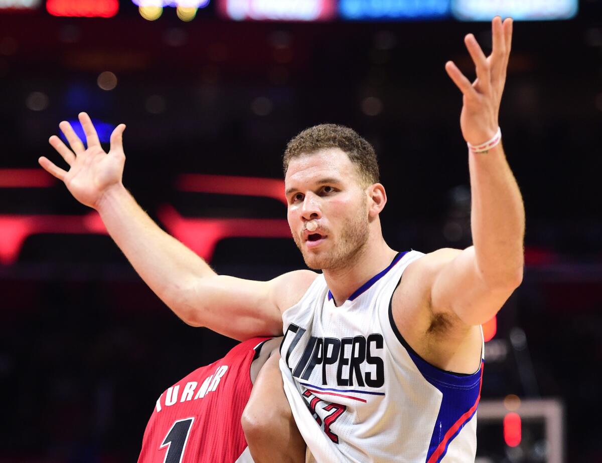 Clippers forward Blake Griffin (32) reacts to the referee for a foul as he is guarded by Trail Blazers forward Evan Turner (1) on Dec. 12.