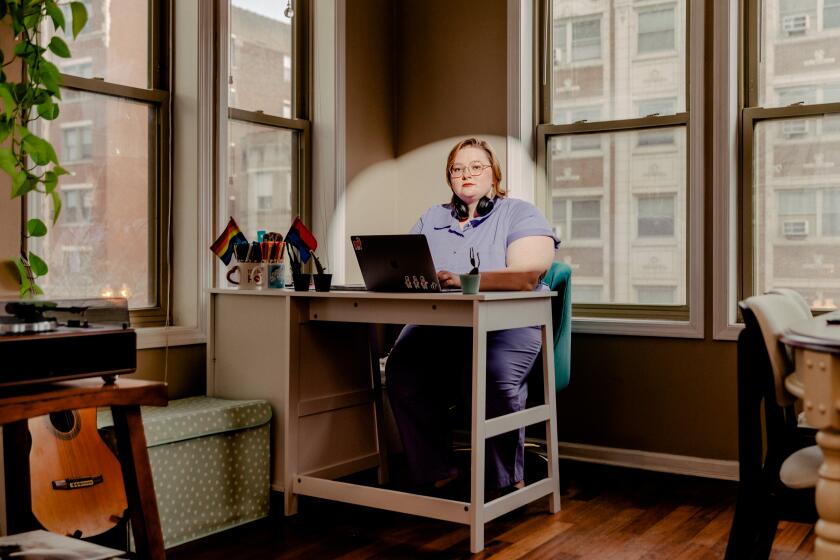 CHICAGO, IL. - March 10, 2022: Margaret Baughman (they/them), former stage manager and director, who now works as a project managaer at Tik Tok sits at their desk at home. CREDIT: (Evan Jenkins / For The Times)